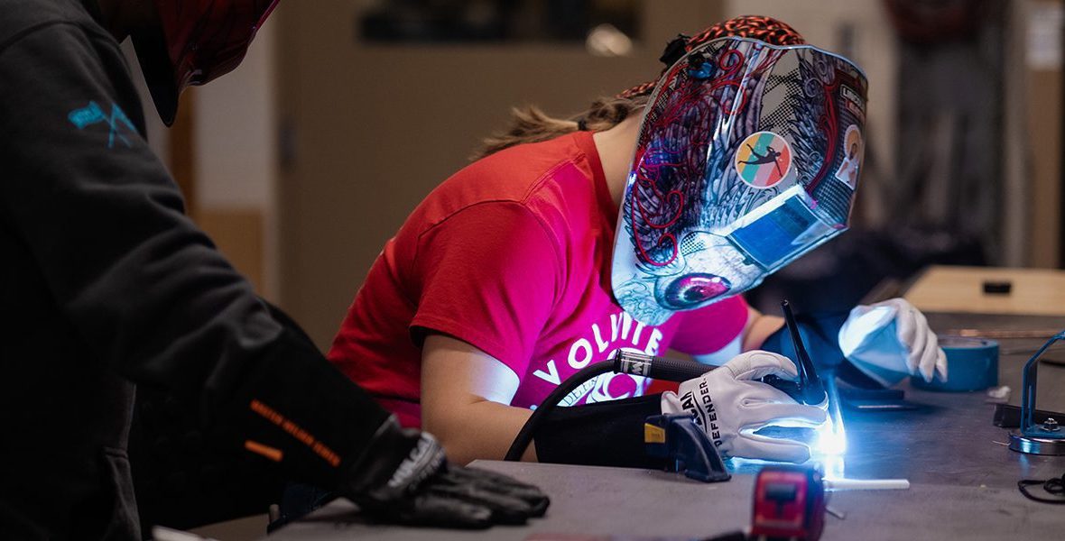 Student working a welder