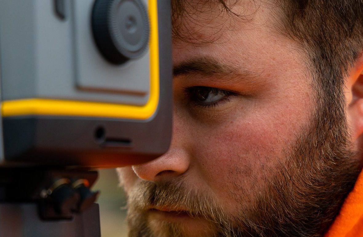 Student using survey equipment